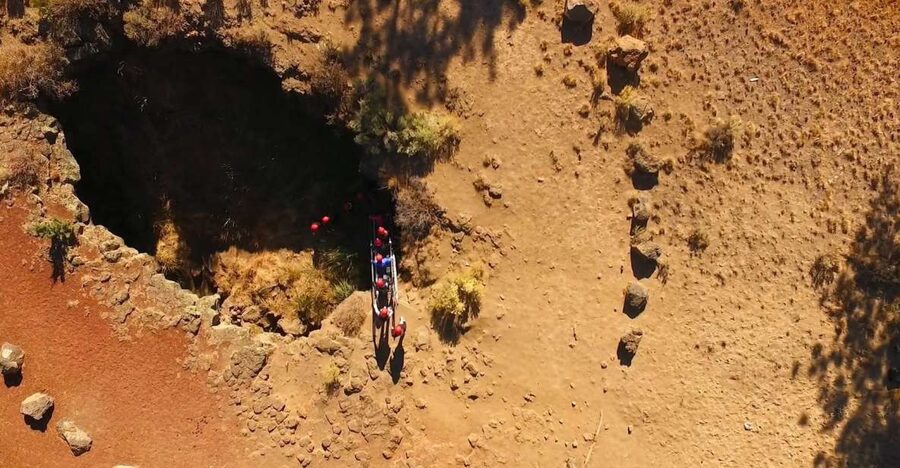 Bend: Half-Day Lava Tube Cave Tour - Entering a cave with no walkways or lights