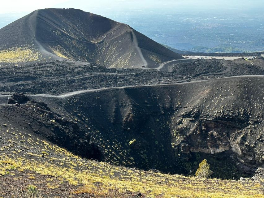 Catania: Etna Morning or Sunset Trek with Lava Tunnel & Gear - Inside the lava tunnel with a helmet and flashlight