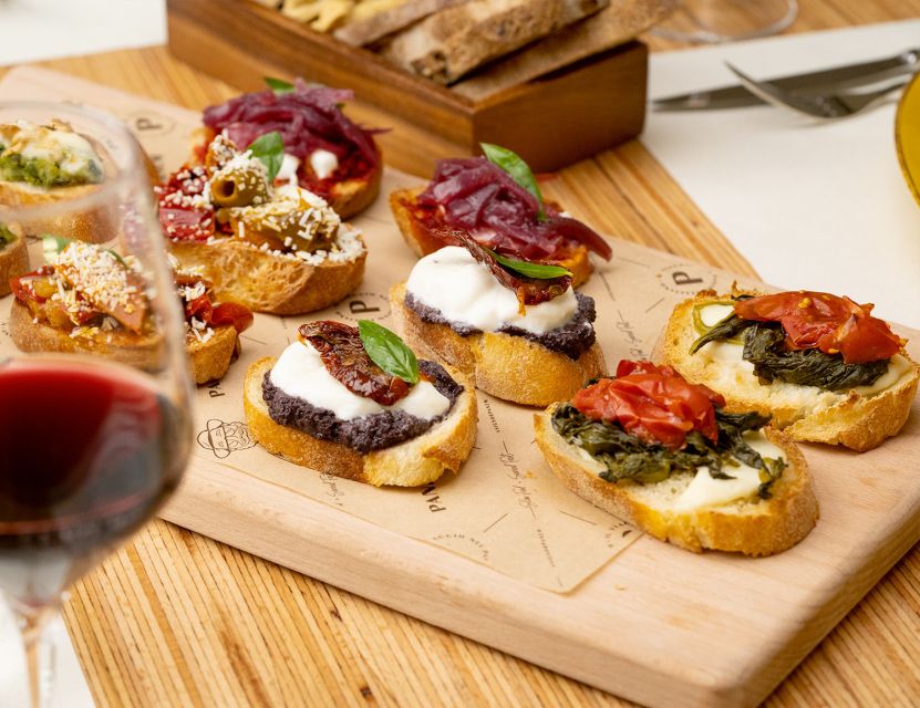 Catania: Volcanic Wine Tasting in a Metropolitan Market - Four glasses with four small plates