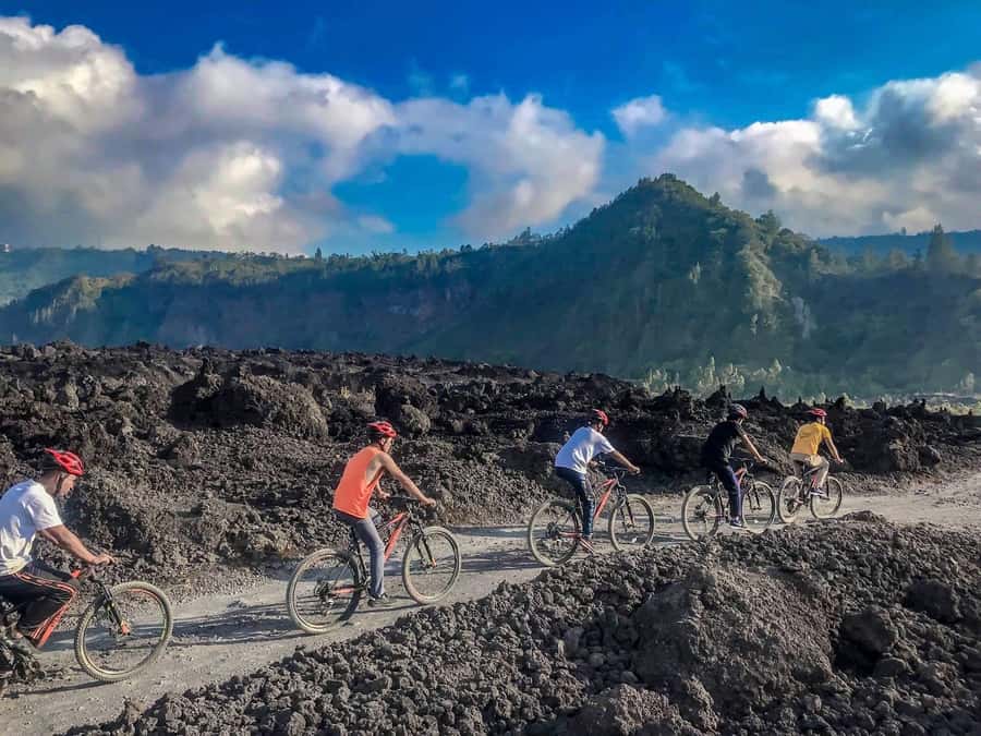 Mount Batur: Black Lava Cycling Tour w/ Natural Hot Spring - Villages, traffic, and a temple by the lake