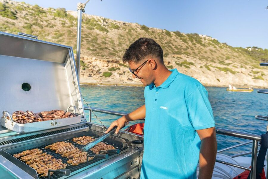 S'Arenal: Sunset Catamaran Cruise with BBQ - Cap Enderrocat and Cala Vella