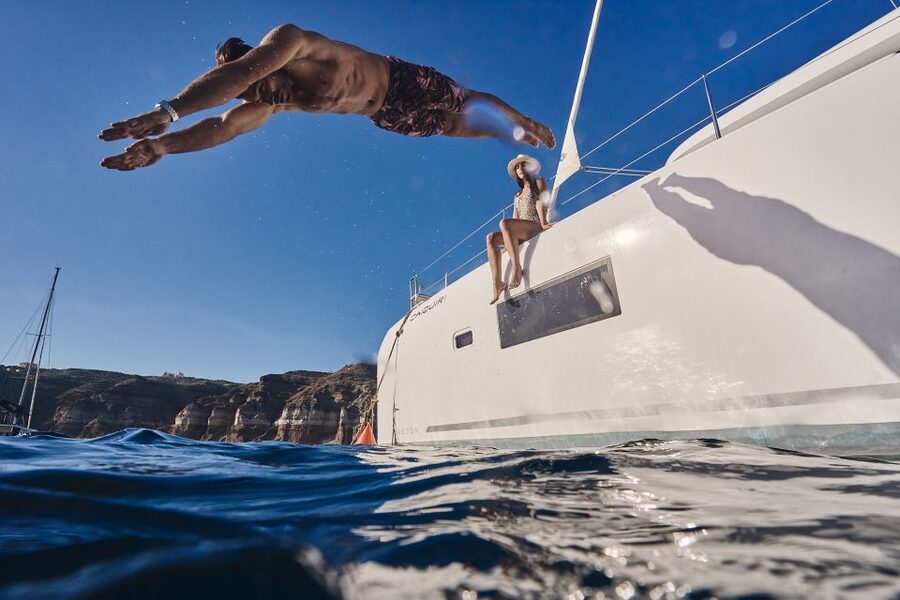 Santorini: Caldera Luxury Catamaran Cruise w/ Meal & Drinks - Red Beach and the southern coast