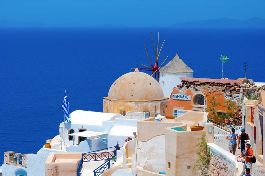 Santorini Island Bus Tour and Caldera Sunset Cruise - Sunset in Oia after the boat ride