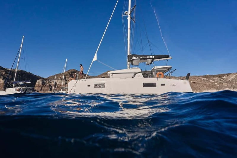 Santorini Oia: Caldera Day Cruise with Snacks & Drinks - Thirassia: the first swim and local snacks
