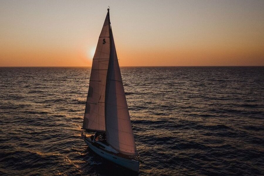 Santorini: Private Caldera Sailing Trip with Open Bar & Meal - Entering the caldera below the Venetian Lighthouse