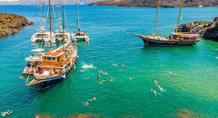 Santorini Volcano, Hot Springs Adventure - Walking across Nea Kameni’s black volcanic ground